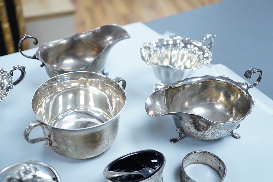 A collection of small silver wares to include a George V silver porringer, two George V silver sauce boats, a let Victorian silver sugar bowl, a George III silver goblet, with later embossed decoration, a George V small